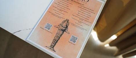 A sign with a QR code and a WhatsApp number for inquiries.