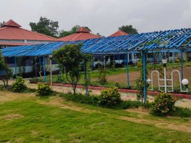 A row of buildings with red roofs and blue awnings.