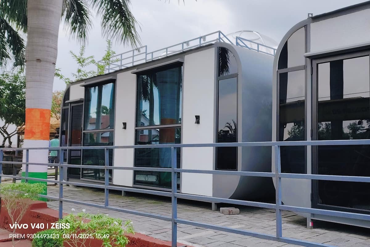 A modern building with large windows and a metal railing.