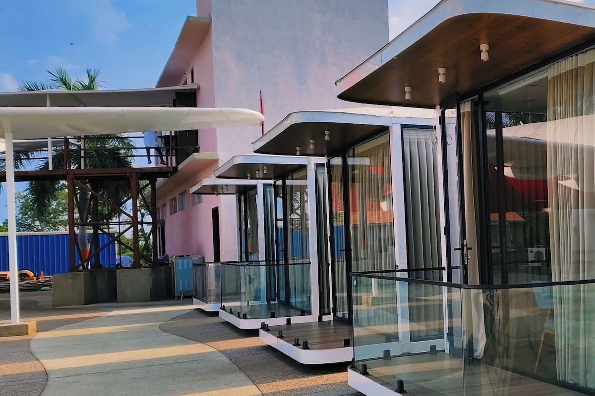 A modern building with large glass windows and a unique architectural design.