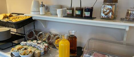 A breakfast buffet with various food items and condiments.