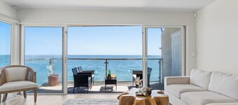Oceanfront Retreat with Multiple Balconies, Direct Beach Access & Sweeping Views