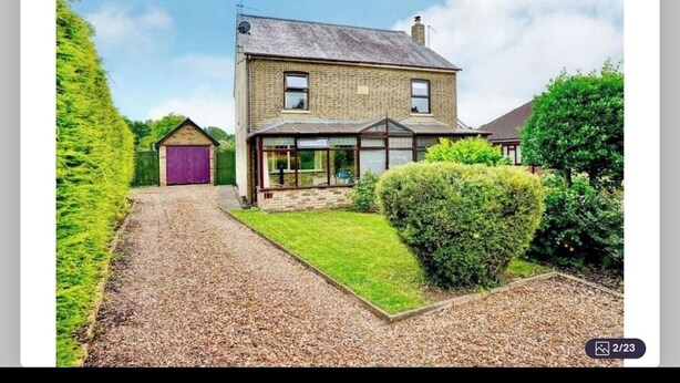 A two-story house with a gravel driveway, a front garden, and a garage. - Peppercorns  (Eaton Socon)