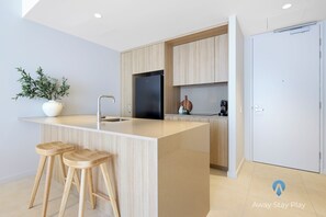Fridge, microwave, oven, stovetop - 708 on CODA – Modern 1BR Apartment with Balcony & City Views (Coffs Harbour)