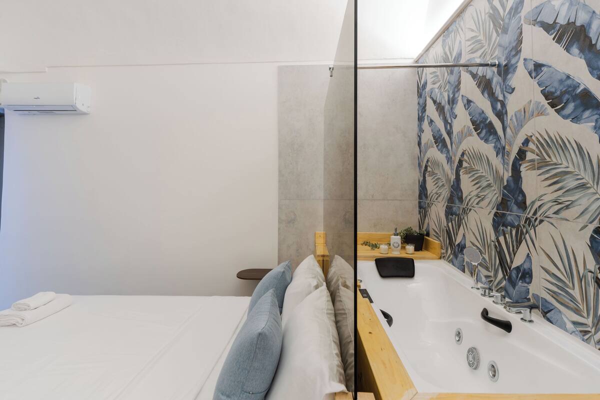 A bathroom with a bathtub, a shower, and a toilet.