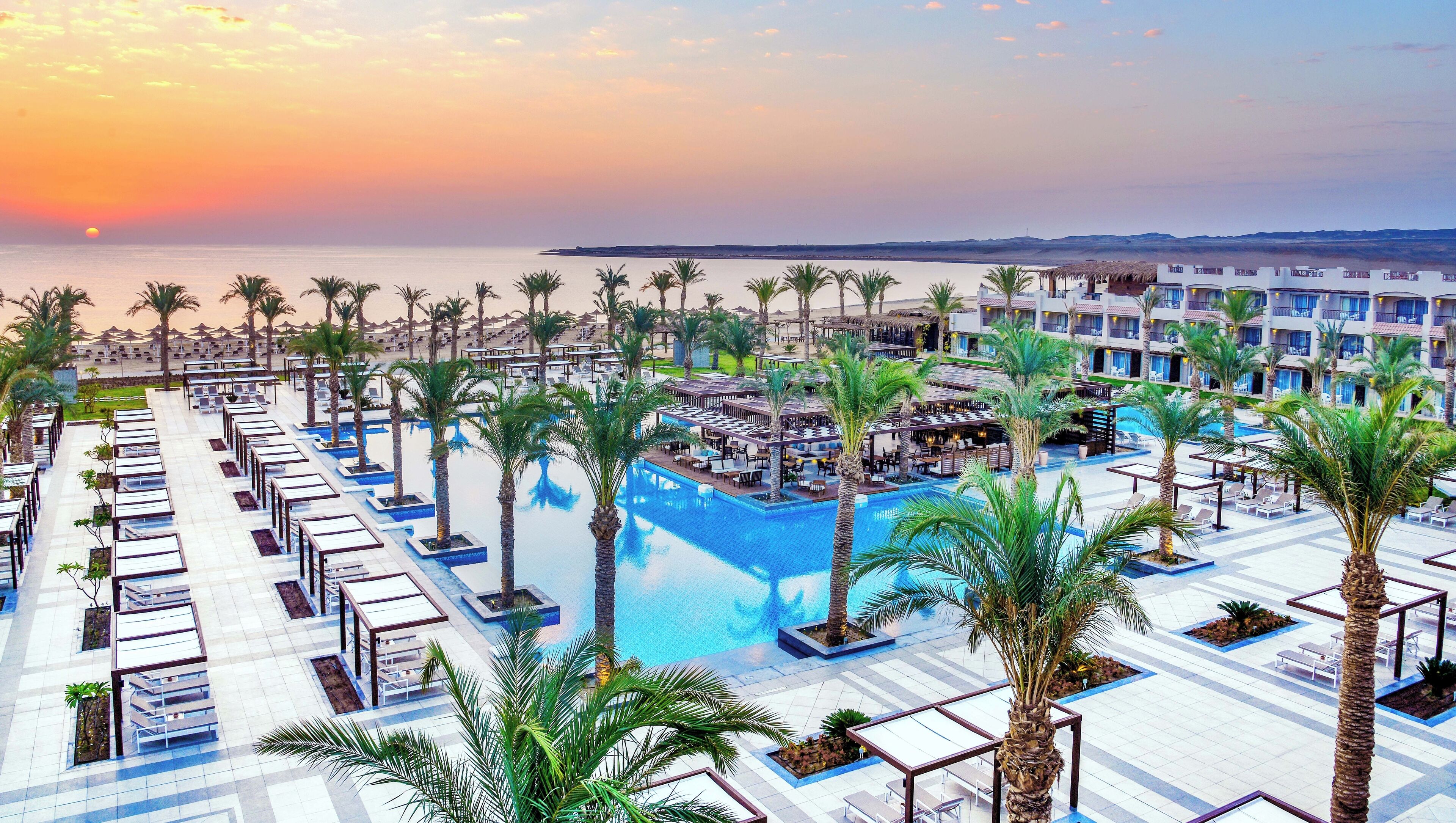 Sip sunset cocktails beside the palm-lined lagoon pool.