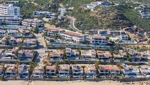A coastal resort with multiple buildings, a beach, and ocean views. - Luxurious Ocean View Retreat at El Encanto! (San Jose del Cabo)
