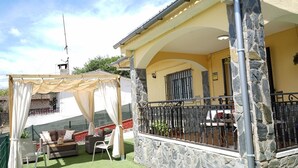 A covered outdoor seating area with a stone wall, a pergola, and a view of the surrounding landscape. - Charming Holiday Home 'Can Dornena Refugio' with Mountain View, Wi-Fi & Air Conditioning (Maçanet de la Selva)