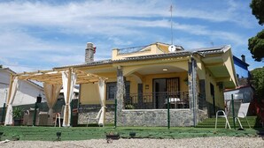 A two-story house with a balcony, a chimney, and a satellite dish. - Charming Holiday Home 'Can Dornena Refugio' with Mountain View, Wi-Fi & Air Conditioning (Maçanet de la Selva)
