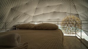A bed with a quilted canopy and a geometric light fixture above it. - Cozy Cabin Retreat in Ortezzano (Ortezzano)
