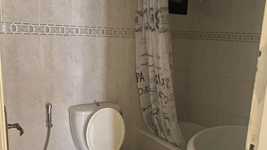 A bathroom with a toilet, shower, and bathtub. - Apartment in the heart of hazmieh (Hazmieh)
