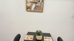 A conference table with two chairs, a potted plant, and a folded towel.