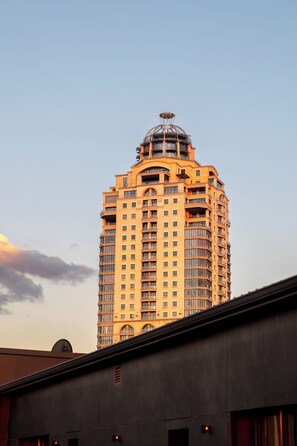 A high-rise hotel with multiple balconies and a distinctive rooftop structure.