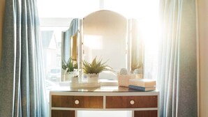 A vanity with a mirror, a potted plant, and toiletries. - No. 66 Chapel Street (Cookstown)