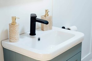 Shower, hair dryer, soap, toilet paper