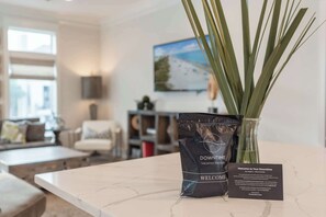A bag of Downtime Vacation Rentals on a counter with a welcome sign. - NEW "Bikinis & Martinis" Private Pool,Gulf Views, Bikes, LSV (Santa Rosa Beach)