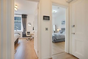 A hotel room with a bed, desk, chair, lamp, and a television. - Jackson Terrace HL6 - Grampian Lettings (Aberdeen)