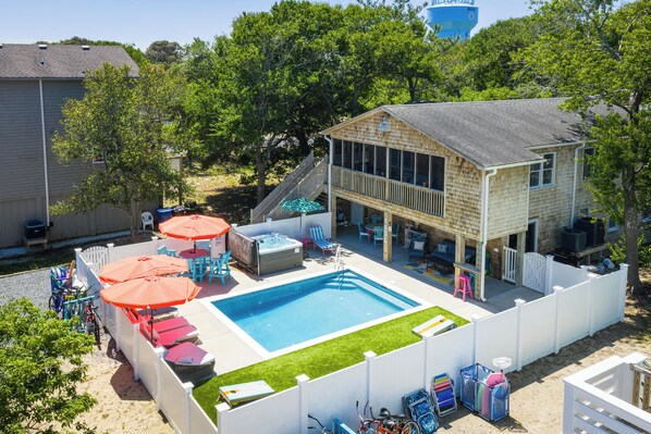 A backyard with a swimming pool, outdoor furniture, and a wooden deck. - This Home Has It All! Location, Amenities, & More! (Duck)