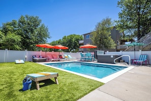 A backyard with a swimming pool, lounge chairs, and a hot tub. - This Home Has It All! Location, Amenities, & More! (Duck)
