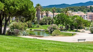 A park with a pond, benches, and a variety of trees and plants. - Stay Near Sanary Harbor & Six-Fours Coastal Walks (Six-Fours-les-Plages)