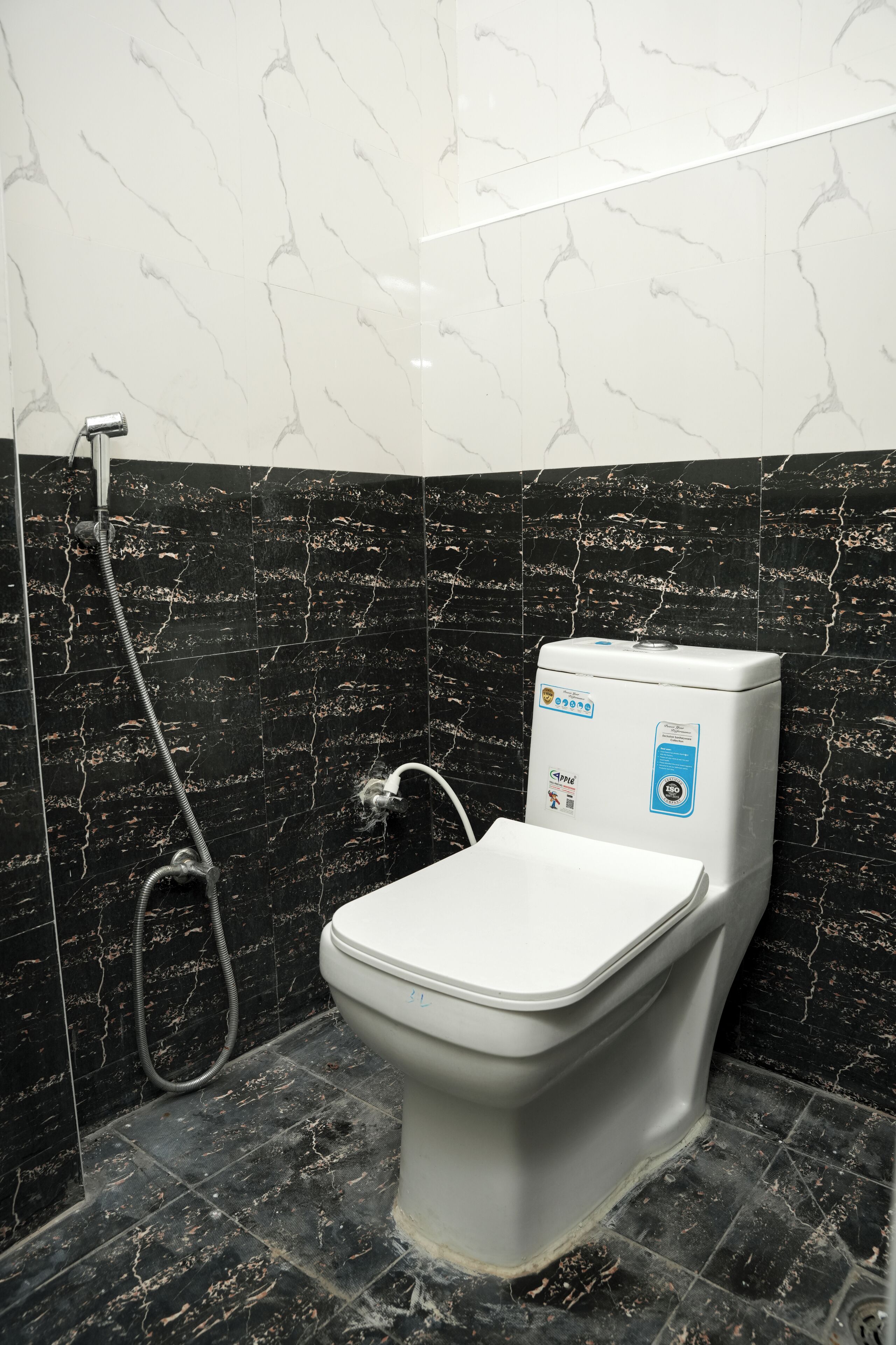 A bathroom with a toilet, a shower, and a water heater.