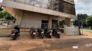 A multi-story building with a modern glass facade and a sign reading "MYTHRI RESIDENCY ACROON & BATHROOMS". - Mythri Residency (Hubli)