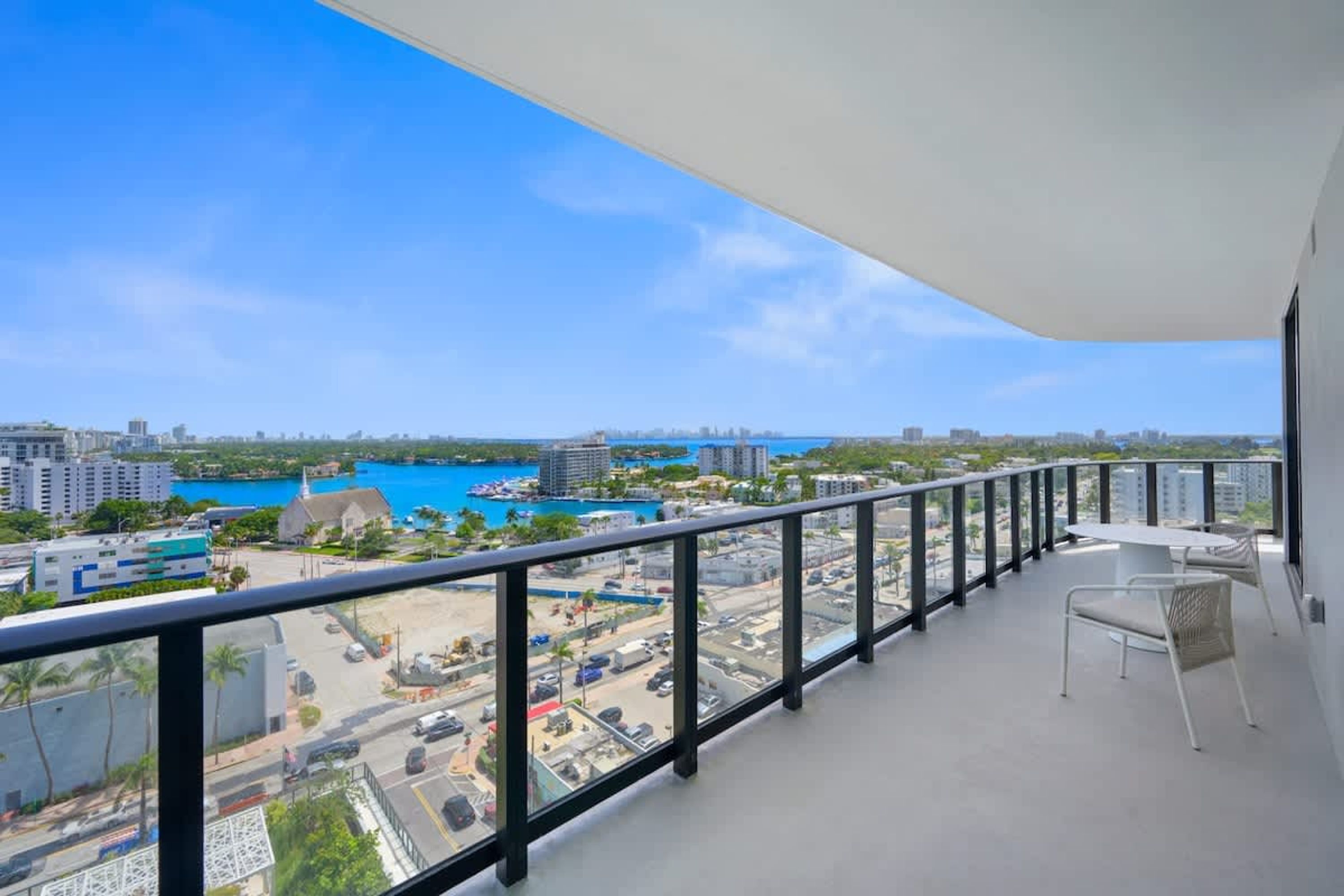A balcony with a view of a marina and cityscape.