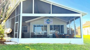 A covered outdoor seating area with a sign for Cypress Gardens Water Ski Team.