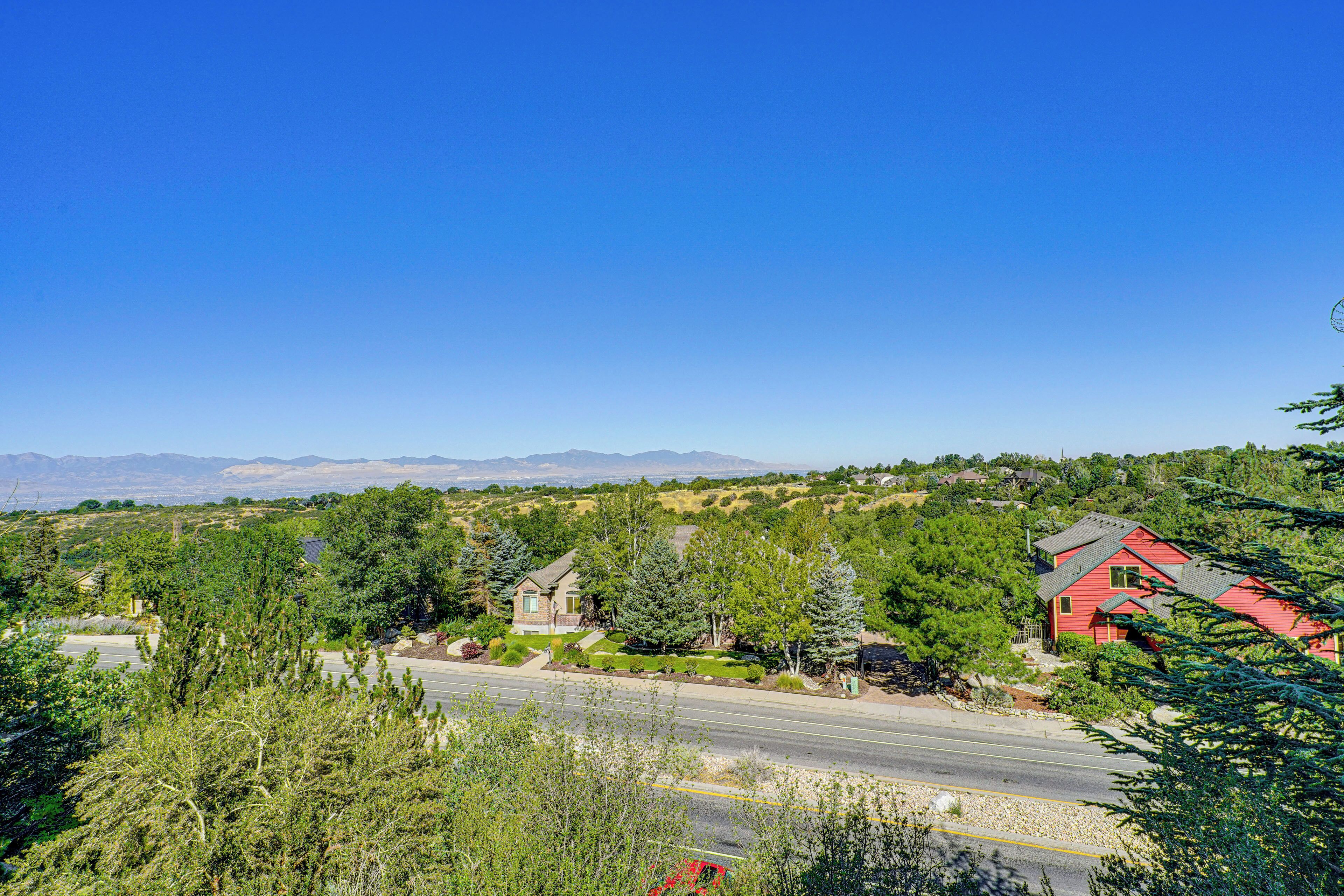 A residential area with houses, a road, and a clear blue sky.