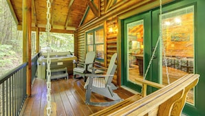 A log cabin with a porch, rocking chairs, and a hot tub. - 1 Mi to Dtwn Gatlinburg: Hot Tub Haven in Smokies! (Gatlinburg)