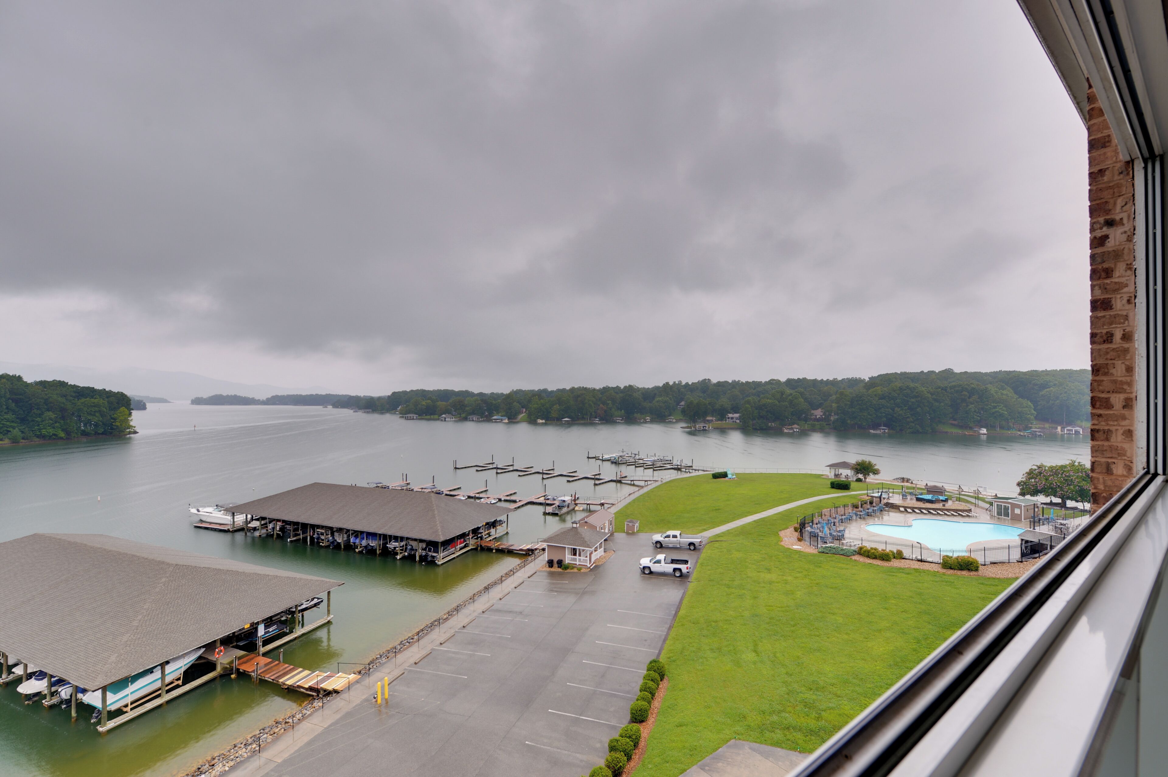 A marina with docks, a swimming pool, and a grassy area.