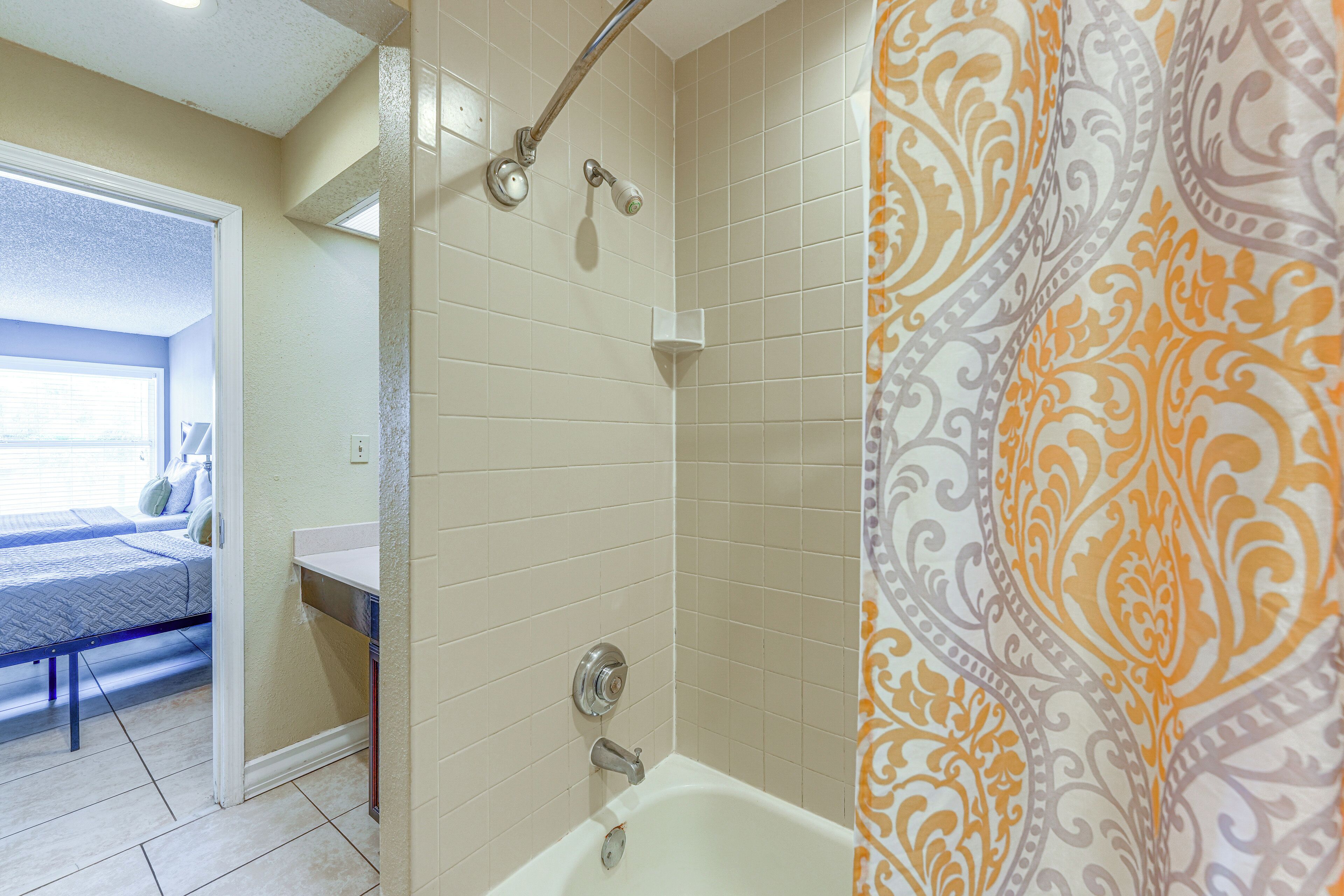 A bathroom with a bathtub, a shower, and a toilet.