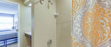 A bathroom with a bathtub, a shower, and a toilet.