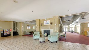 A spacious lobby with a fireplace, seating area, and a reception desk. - 2 Mi to Disney: Resort Condo w/ Pool Access (Kissimmee)