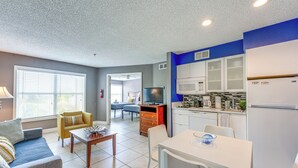 A compact living space with a kitchenette, a dining area, and a seating area with a sofa and chairs. - 2 Mi to Disney: Resort Condo w/ Pool Access (Kissimmee)