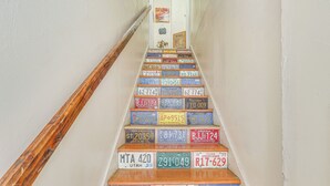 A staircase with steps covered in various license plates from different states.