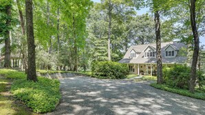 A house surrounded by a forested area with a gravel driveway leading to the entrance. - Golf, Hike & Explore: Blue Ridge Mtn Haven w/ Deck (Roaring Gap)