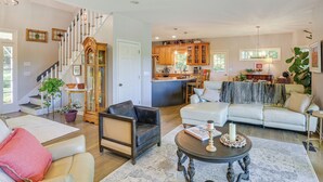 A spacious living room with a staircase, a kitchen area, and a dining space. - Golf, Hike & Explore: Blue Ridge Mtn Haven w/ Deck (Roaring Gap)
