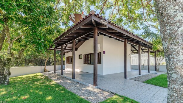 A covered outdoor area with a pergola structure, a white wall, and a number '126' sign. - 3BR Home w/ BBQ 140m From the Beach Rae0126 (Bombinhas)