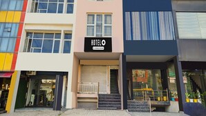 A hotel with a sign reading 'HOTEL' and a company service logo. - Hotel O Green City Dhakoli Formerly Swagat (Dera Bassi)
