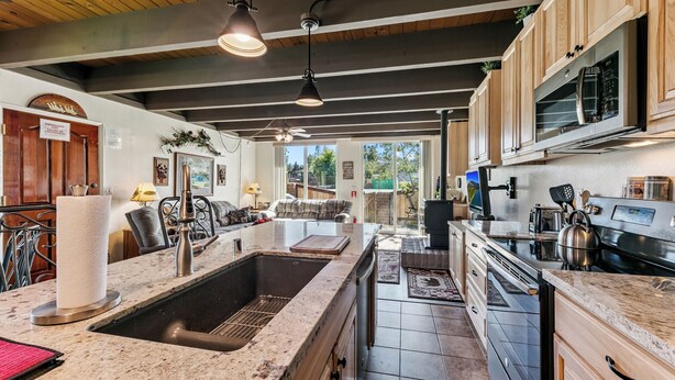 A spacious kitchen with granite countertops, stainless steel appliances, and wooden cabinets. - 439AW Tahoe Keys Studio Perfect Couples Get Away (South Lake Tahoe)
