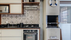 A modern kitchen with a built-in oven, microwave, and stainless steel appliances. - PVI - Charming Apartments Just 450m From the Seafront in Ubatuba/sp (Ubatuba)