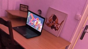 A wooden desk with a laptop, a chair, and a framed picture on the wall. - Your apartment with free prking in St Etienne (Saint-Étienne)