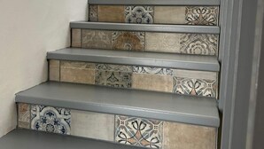 A staircase with multiple steps, each featuring a different tile pattern. - Golf Course House with 3 Terraces, heated pool, tennis acess, near beach (Marbella)