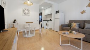 Una sala de estar moderna con sofá, mesa de centro y comedor.