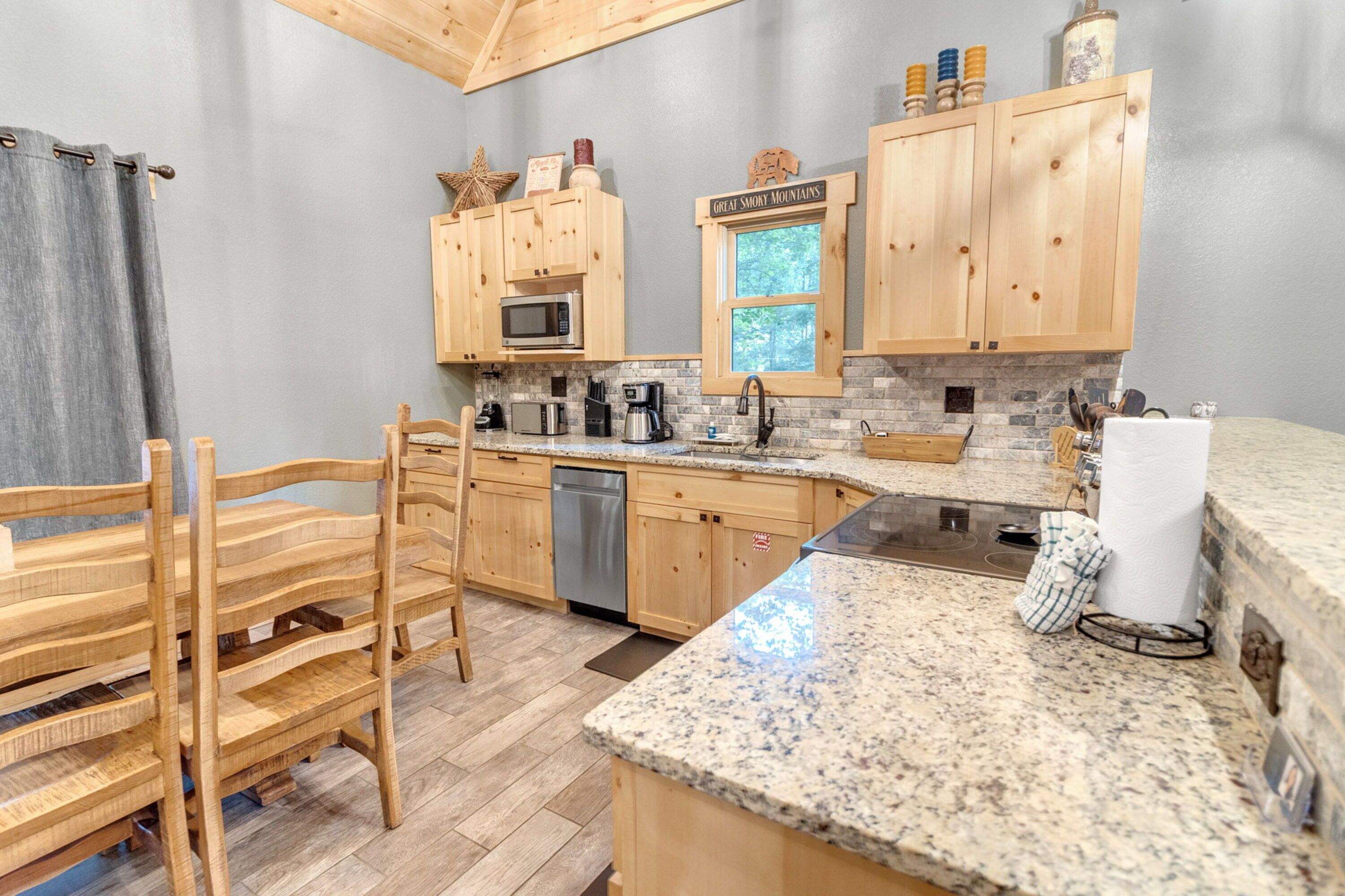 A kitchen with wooden cabinets, granite countertops, a microwave, and a coffee maker.