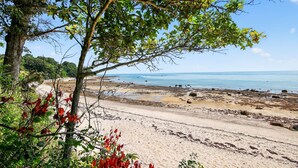 A beach with sandy shores, trees, and a clear view of the sea. - Ocean Views & Private Beach 3br Nature Escape 3 Bedroom Villa (Plymouth)