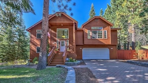 A two-story wooden house with a garage, surrounded by trees. - 1272g Where Eagles Fly 3 Bedroom Home (South Lake Tahoe)