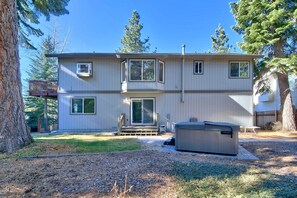 A two-story house with a deck, a hot tub, and a well-maintained yard. - 2272l The Lupine Lodge 3 Bedroom Home (South Lake Tahoe)