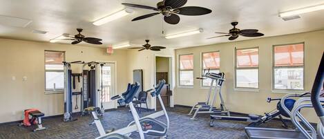 A gym with treadmills, elliptical machines, and weightlifting equipment.